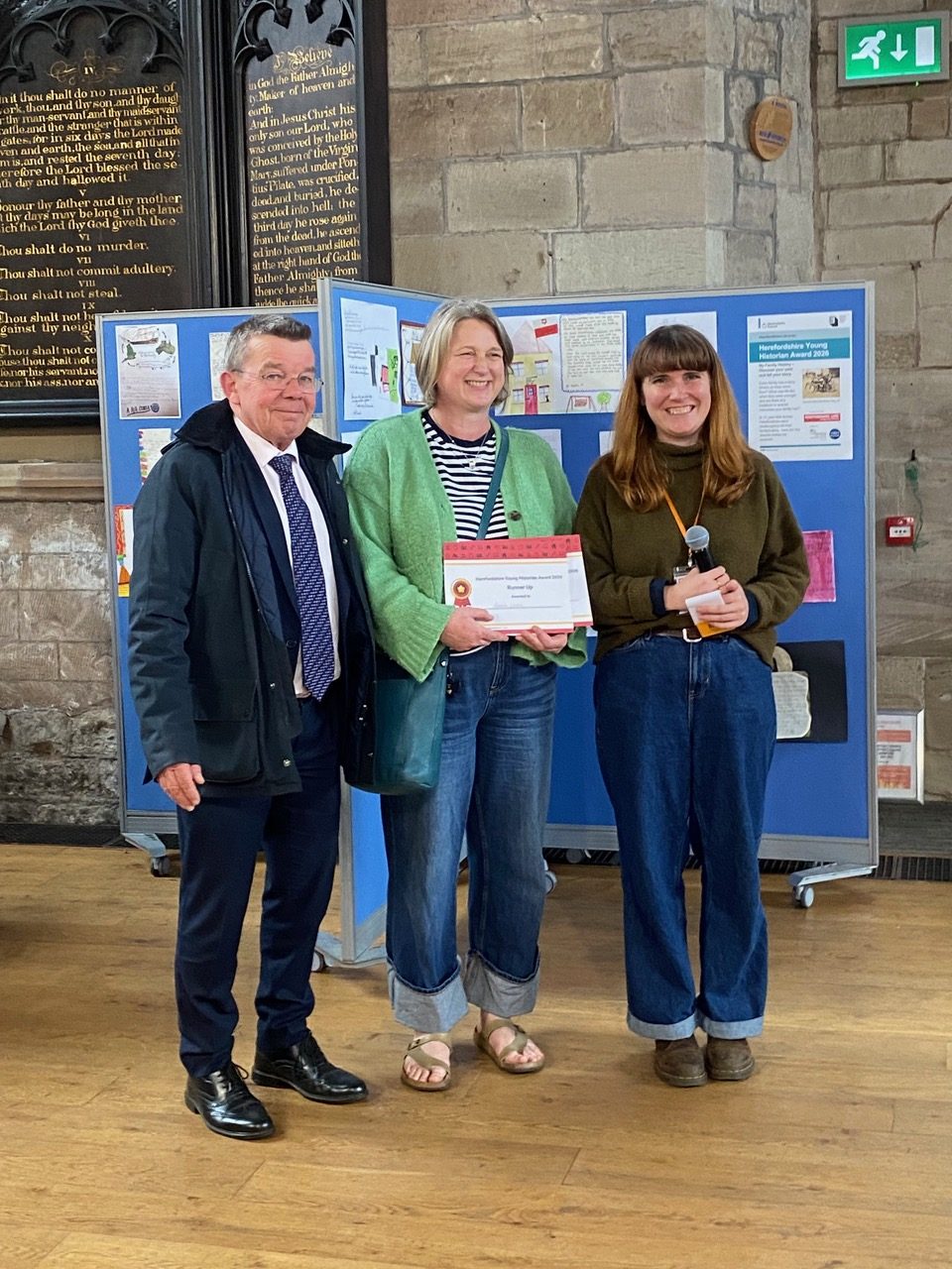 St Thomas Cantilupe teacher Kahlia Laws (centre) accepts the school’s Young Historian Award presentation from estate agent Stephen Thomas and (right) organiser Francesca Davies.